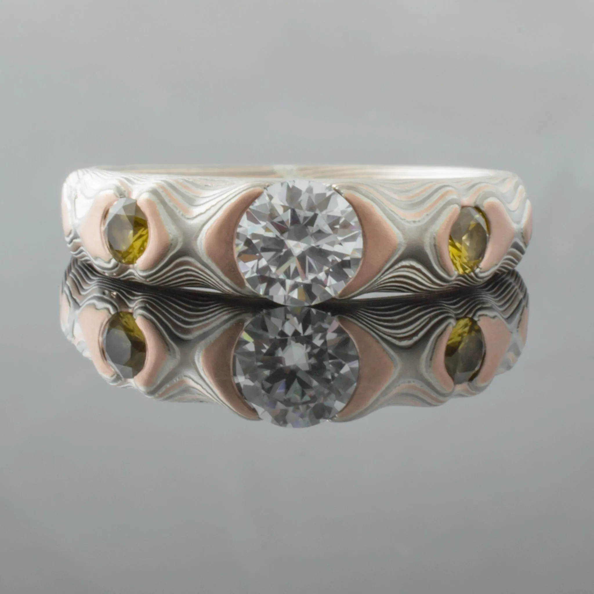 Earthy Mokume Gane Engagement Ring in Guri Bori Pattern and Embers Palette with Cathedral Set Moissanite